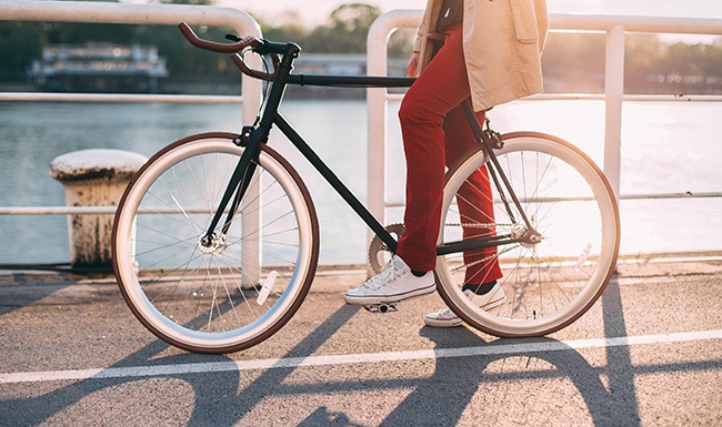 Life on the Riverside lifestyle image of a person riding their bicycle at sunset