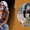 lifestyle image of women drinking wine beside friends at a coffee shop with their pet dog